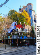 Hundertwasser house in Vienna, Austria. The Hundertwasserhaus apartment block has colorful facade, undulating floors, a roof covered with earth and grass, and large trees growing from inside (2019 год). Редакционное фото, фотограф Nataliia Zhekova / Фотобанк Лори