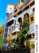 Hundertwasser house in Vienna, Austria. The Hundertwasserhaus apartment block has colorful facade, undulating floors, a roof covered with earth and grass, and large trees growing from inside (2019 год). Стоковое фото, фотограф Nataliia Zhekova / Фотобанк Лори
