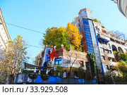 Hundertwasser house in Vienna, Austria. The Hundertwasserhaus apartment block has colorful facade, undulating floors, a roof covered with earth and grass, and large trees growing from inside (2019 год). Стоковое фото, фотограф Nataliia Zhekova / Фотобанк Лори