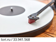 Old-fashioned turnable record player on a wooden background. Стоковое фото, фотограф Ярослав Данильченко / Фотобанк Лори