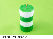 White and green striped cylindrical handmade candle. Стоковое фото, фотограф Nataliia Zhekova / Фотобанк Лори