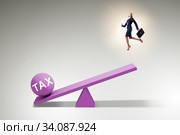 Businesswoman in tax concept with seesaw. Стоковое фото, фотограф Elnur / Фотобанк Лори