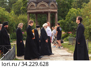 Russia, Veliky Novgorod, Yuriev monastery-July 14, 2020: Archimandrite ili (Nozdrin), Metropolitan Lev of Novgorod and old Russia, Bishop Arseniy of Yuriev together with the monastery's brethren approach the Spassky Cathedral. Редакционное фото, фотограф Филатова Ирина / Фотобанк Лори
