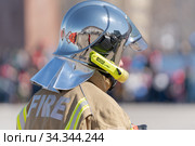Back view of inscription Fire on uniform firefighter Emercom of Russia, Ministry of Civil Defence, Emergencies and Disaster Relief Russian Federation MChS (2019 год). Редакционное фото, фотограф А. А. Пирагис / Фотобанк Лори