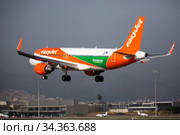 Airline EasyJet plane comes in for a landing in an aeroport El Prat city of Barcelona. Board number OE-IVT (2020 год). Редакционное фото, фотограф Яков Филимонов / Фотобанк Лори