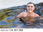 Russia Samara December 2019: a young man is swimming in the ice hole in winter. Редакционное фото, фотограф Акиньшин Владимир / Фотобанк Лори