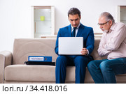 Young male lawyer visiting old man in testament concept. Стоковое фото, фотограф Elnur / Фотобанк Лори