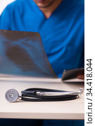 Young male doctor in telemedicine concept. Стоковое фото, фотограф Elnur / Фотобанк Лори