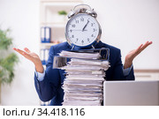 Young male employee unhappy with excessive work. Стоковое фото, фотограф Elnur / Фотобанк Лори