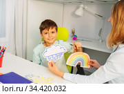 Autistic boy during ABA therapy with weather cards. Стоковое фото, фотограф Сергей Новиков / Фотобанк Лори