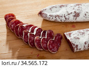 Spanish sausage fuet on a wooden table, closeup. Стоковое фото, фотограф Яков Филимонов / Фотобанк Лори