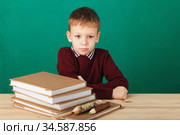 Young boy looking angry shaking his fists tired of school lessons, education. Tiredness stressing overworking children expressive emotional furious mad learning. Back to School. Стоковое фото, фотограф Nataliia Zhekova / Фотобанк Лори