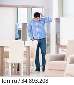 Young man shopping in furniture store. Стоковое фото, фотограф Elnur / Фотобанк Лори