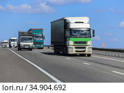 Many trucks moving along the highway. Стоковое фото, фотограф Юрий Бизгаймер / Фотобанк Лори