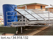 Solar glass water panel array mounted on a roof for heating. Huge tank for hot water. Alanya, Turkey. Стоковое фото, фотограф Кекяляйнен Андрей / Фотобанк Лори