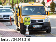 Yellow cab stands on the special parking place for taxi cars. Van with opened doors is waiting for passengers. Taxi service is in Alanya city. Turkey (2020 год). Редакционное фото, фотограф Кекяляйнен Андрей / Фотобанк Лори