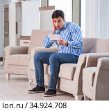 Young man shopping in furniture store. Стоковое фото, фотограф Elnur / Фотобанк Лори