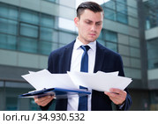 Financial director is examining documents before signing. Стоковое фото, фотограф Яков Филимонов / Фотобанк Лори