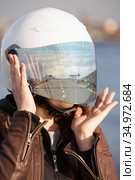 Portrait of unrecognizable European female motorcyclist with road reflection in her mirrored tinted visor of a helmet, collage. Стоковое фото, фотограф Кекяляйнен Андрей / Фотобанк Лори