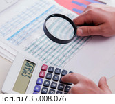 Finance analyst looking and financial reports. Стоковое фото, фотограф Elnur / Фотобанк Лори