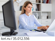 Office manager works with documents and laptop. Стоковое фото, фотограф Яков Филимонов / Фотобанк Лори