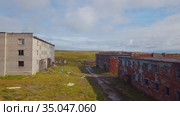 Aerial view of an abandoned village Cape Skorbeewski - a former military garrison on the Peninsula Rybachiy, Russia. Стоковое видео, видеограф Aleksandr Lutcenko / Фотобанк Лори