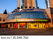 Russia Samara September 2019: the entrance to a large beautiful supermarket Crossroads as in the rays of a sunny sunset on a summer day. Russian text: Crossroads, supermarket, business guarantor, group of companies, sports, proper nutrition, fitness. Редакционное фото, фотограф Акиньшин Владимир / Фотобанк Лори