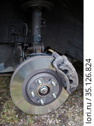 Worn out steel ventilated brake disk with fixed calliper and brake pads are ready for removing, front wheel. Стоковое фото, фотограф Кекяляйнен Андрей / Фотобанк Лори
