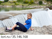 Portrait of pre-teen girl resting close to waterfall of the Cijevna river. It is called Montenegrin Niagara Falls. Surroundings of Podgorica city. Montenegro, Europe. Стоковое фото, фотограф Кекяляйнен Андрей / Фотобанк Лори