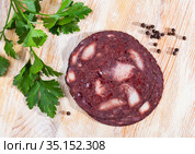 black puddingon served with parley on plate on wooden table. Стоковое фото, фотограф Яков Филимонов / Фотобанк Лори