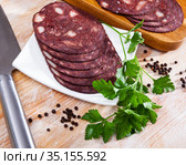 European cuisine blood pudding served with parley on white plate on wooden table. Стоковое фото, фотограф Яков Филимонов / Фотобанк Лори