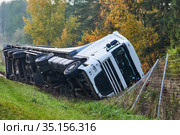 Long vehicle crash. Lorry overturned in ditch at the side of road. Стоковое фото, фотограф Дмитрий Калиновский / Фотобанк Лори