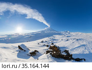 Kamchatka Peninsula, winter mountain landscape, beautiful panoramic view of eruption active volcano in clear sunny weather with blue sky. Стоковое фото, фотограф А. А. Пирагис / Фотобанк Лори