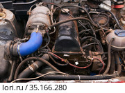 Old dirty car engine with numerous modifications under the hood. Стоковое фото, фотограф Евгений Харитонов / Фотобанк Лори