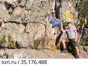a mature sports couple on the top of Aleksandrovskaya Sopka mountain near the town of Zlatoust in the Chelyabinsk region in Russia. Стоковое фото, фотограф Акиньшин Владимир / Фотобанк Лори