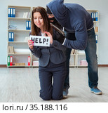Criminal taking businesswoman as hostage in office. Стоковое фото, фотограф Elnur / Фотобанк Лори