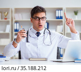 Male doctor in anti-smoking conceptwithcigarette pack. Стоковое фото, фотограф Elnur / Фотобанк Лори