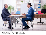 Yound and old employees in business presentation concept. Стоковое фото, фотограф Elnur / Фотобанк Лори