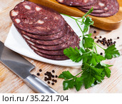 European cuisine blood pudding served with parley on white plate on wooden table. Стоковое фото, фотограф Яков Филимонов / Фотобанк Лори