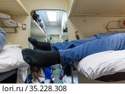 Male legs in black socks in the aisle of a train car. Стоковое фото, фотограф Володина Ольга / Фотобанк Лори