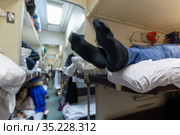 Male legs in black socks in the aisle of a train car. Стоковое фото, фотограф Володина Ольга / Фотобанк Лори