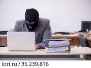 Young male employee in industrial espionage concept. Стоковое фото, фотограф Elnur / Фотобанк Лори