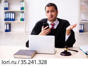 Young male lawyer working in the courthouse. Стоковое фото, фотограф Elnur / Фотобанк Лори
