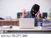Young male employee in industrial espionage concept. Стоковое фото, фотограф Elnur / Фотобанк Лори