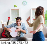 Young family singing and playing music at home. Стоковое фото, фотограф Elnur / Фотобанк Лори