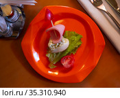 Devilled egg in shape of ship with sausage slice and fresh vegetables. Стоковое фото, фотограф Яков Филимонов / Фотобанк Лори