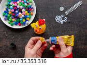 детские руки приклеивают клеем из тюбика крыло к фигурке цыпленка. Стоковое фото, фотограф Иванов Алексей / Фотобанк Лори