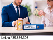Young male lawyer and old man in testament and time management c. Стоковое фото, фотограф Elnur / Фотобанк Лори