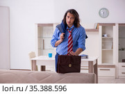 Young male employee being fired from his work at home. Стоковое фото, фотограф Elnur / Фотобанк Лори