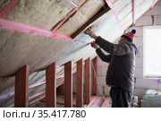 A man insulates an attic. Стоковое фото, фотограф Типляшина Евгения / Фотобанк Лори